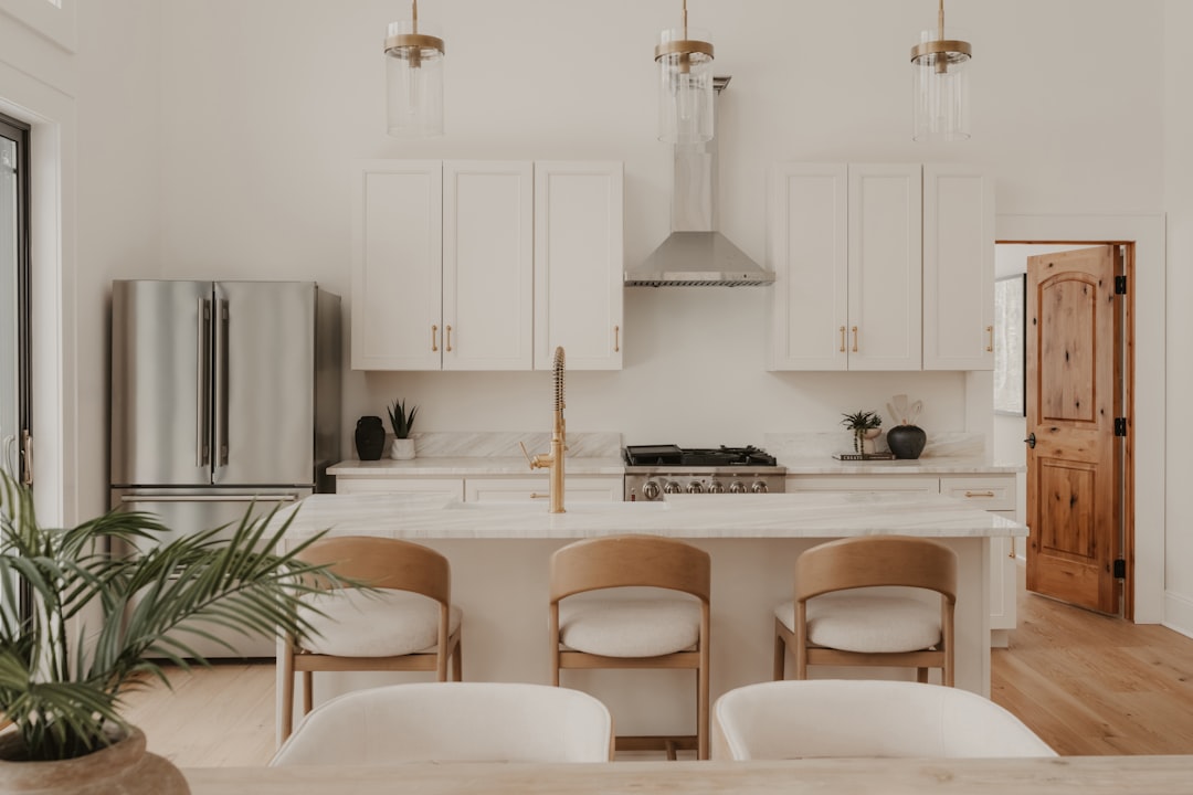 A set of modern house keys rests on top of a real estate contract on a clean, bright surface, representing the connection between a property transaction and its legal paperwork.