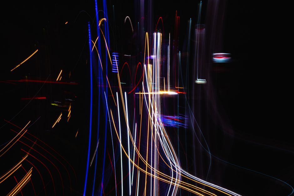 An abstract technological background with glowing lines of light representing complex data and AI-powered networks, conveying innovation and connectivity.